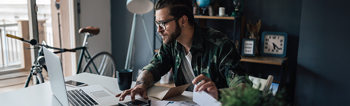 guy at desk looking at computer