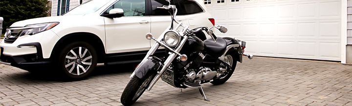 Motorcycle and car bundled with insurance in front of house