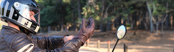 Motorcycle rider trying out helmet and riding gear